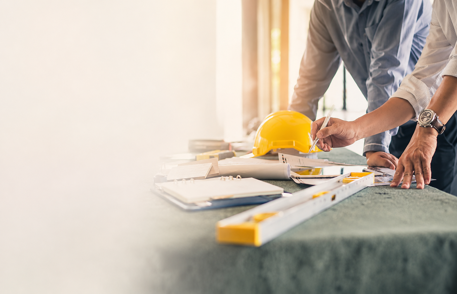 Contractors reviewing construction plans and project costs